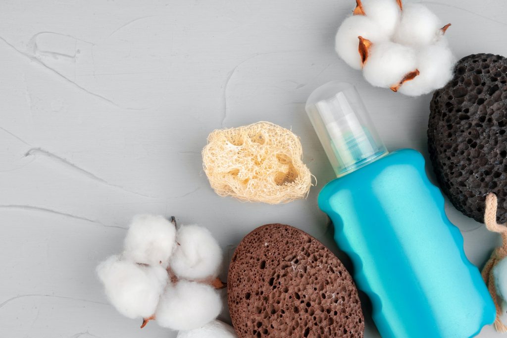 Plastic bottles of body care and beauty products composition close up